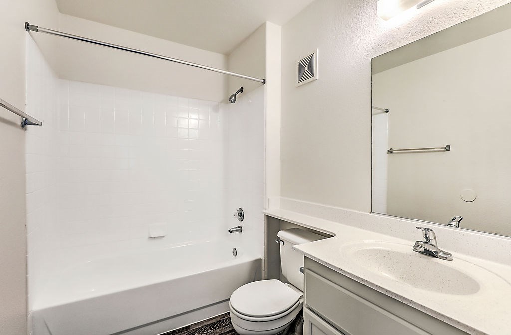 a bathroom with a sink toilet and a tub