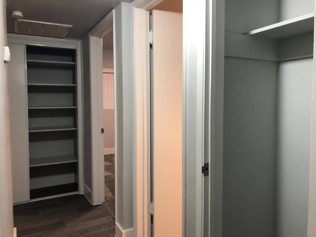 a room with a closet and a staircase and a door open