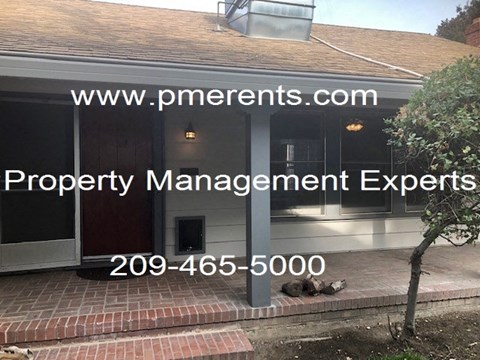 A house with a sign that says Property Management Experts.