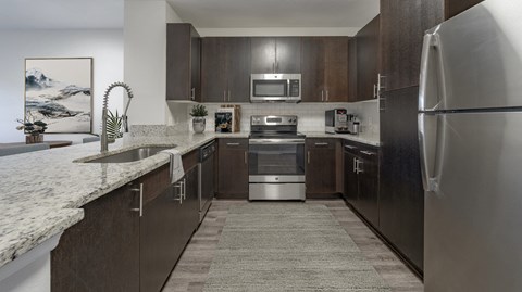 a kitchen with stainless steel appliances and marble counter tops