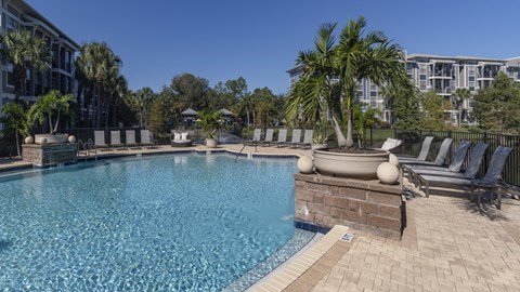 a swimming pool at a resort with palm trees