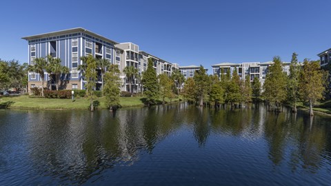 a building overlooking a body of water with trees