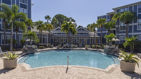 a large swimming pool in front of an apartment building
