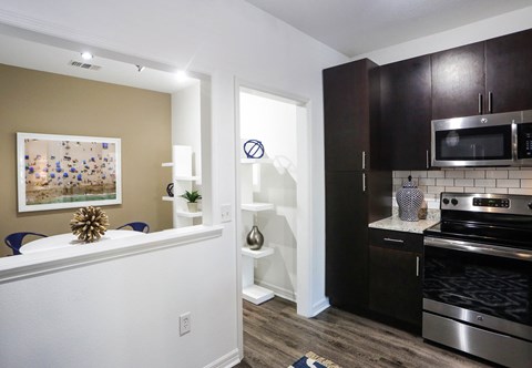 a kitchen with stainless steel appliances and a counter top with a sink