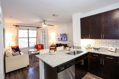 full kitchen and living room at the district flats apartments in lenexa