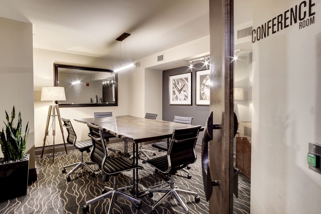a conference room with a wooden table and chairs