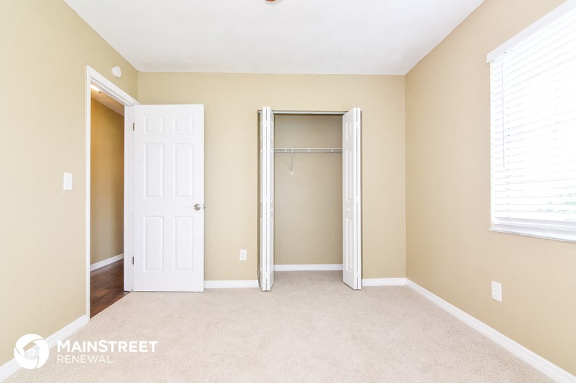 a bedroom with a closet and an open door