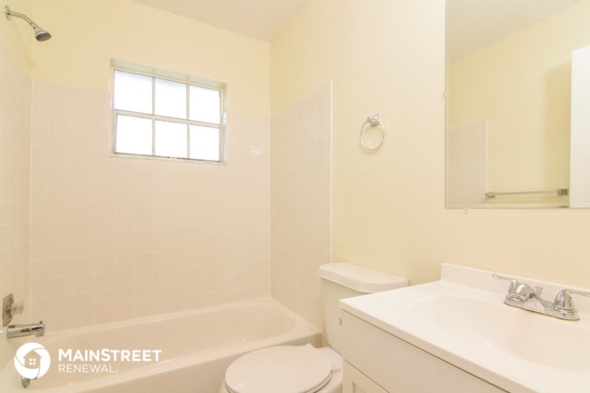 a bathroom with a sink toilet and a bath tub