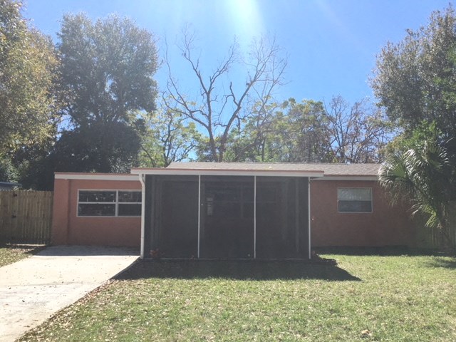 a small house with a garage and a lawn