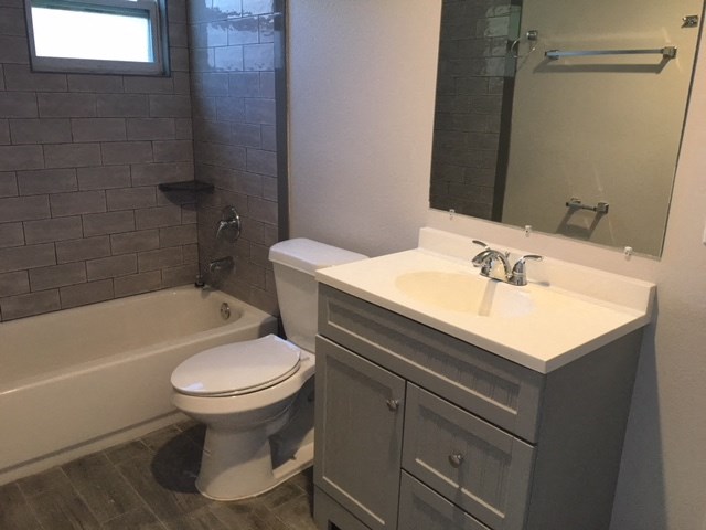 a bathroom with a sink toilet and a bath tub