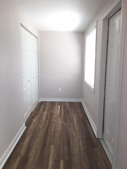 a empty room with wooden floors and white walls