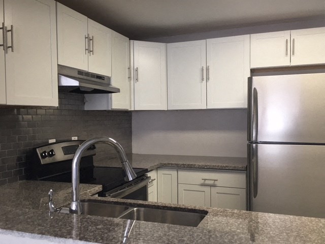 a kitchen with a sink and a refrigerator