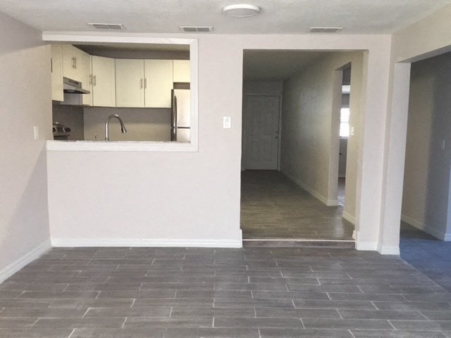 an empty living room and kitchen in a house