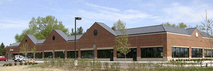 a brick building with cars parked outside of it
