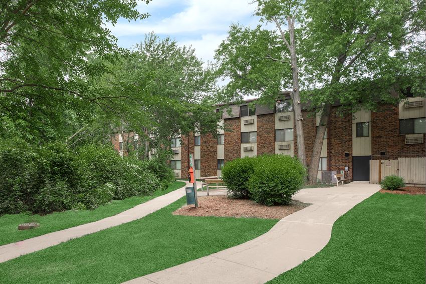 our apartments are located in a quiet neighborhood with green grass and trees