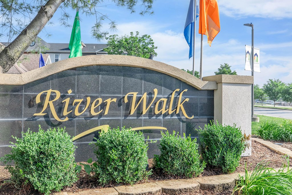 the sign for river walk at the entrance to the city of river walk