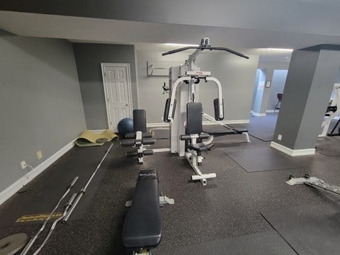 a gym with weights and other equipment on the floor