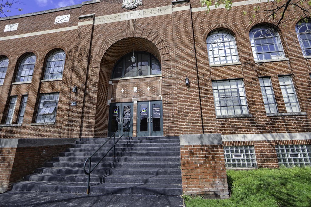 a large brick building with stairs in front of it