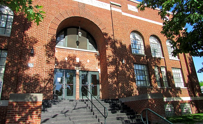 a large brick building with stairs and a door