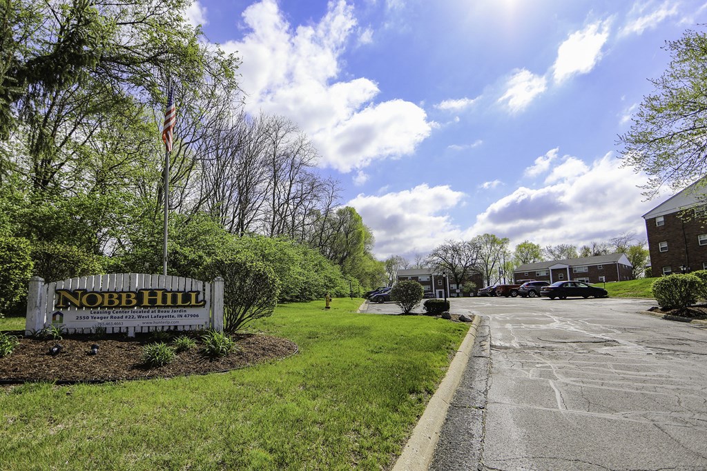 a sign apartments on the side of a road