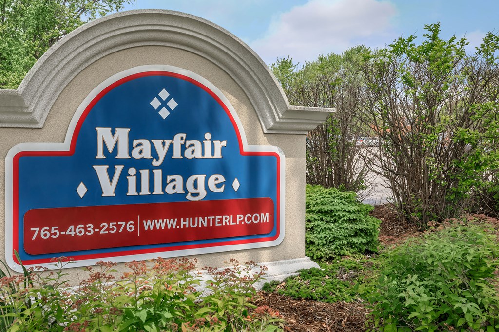 a sign in front of trees