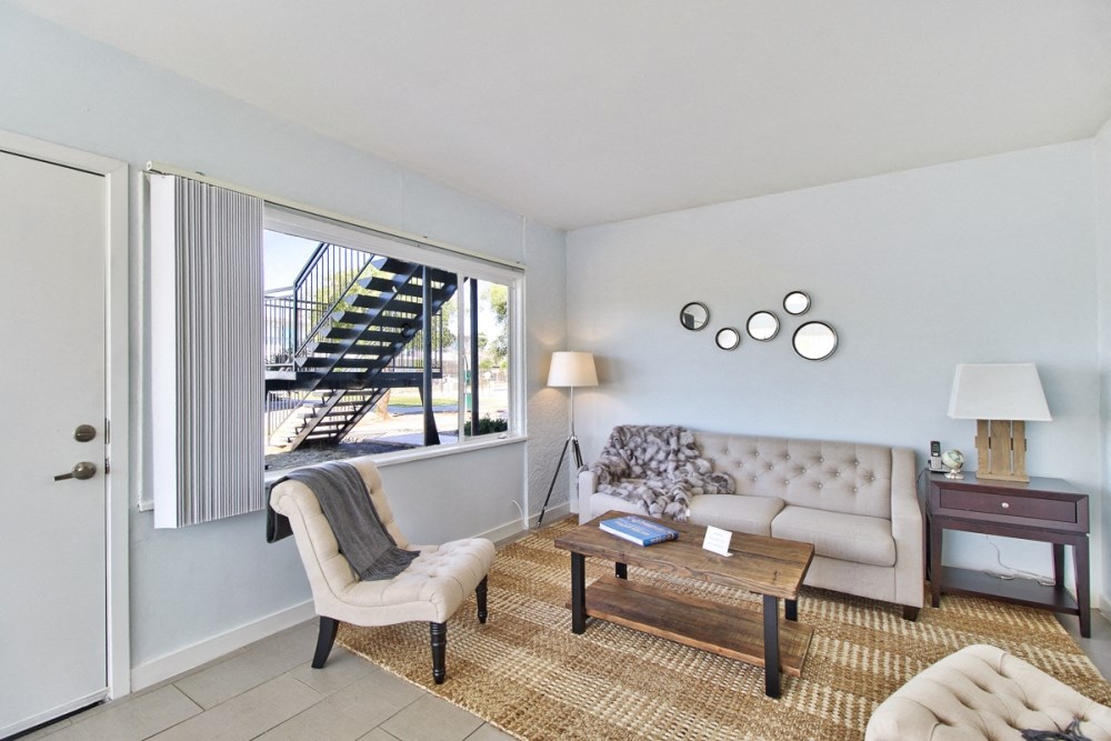 a living room with a couch and a table and a window