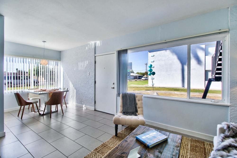 a living room and dining room with a sliding glass door