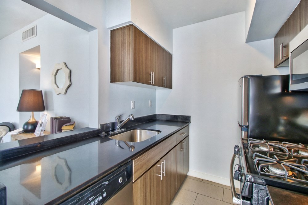 a kitchen with a sink and a stove and a refrigerator