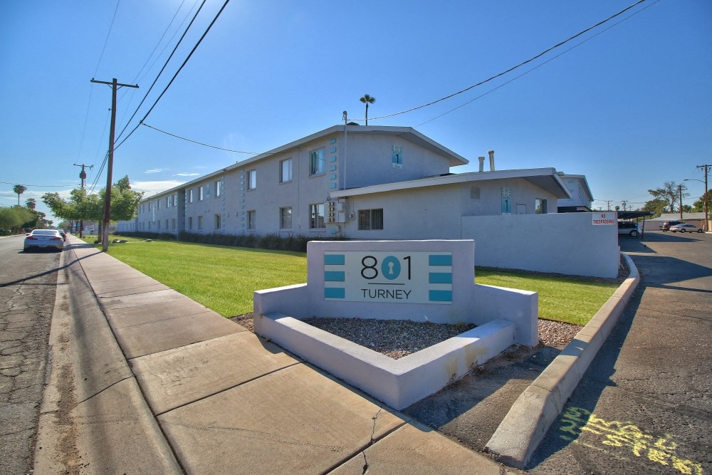 a long white building with a sign that says 801 tunnyy in front