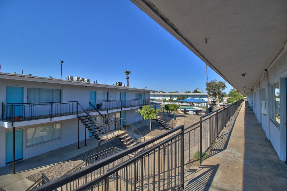the view from the balcony of a condo building with stairs and balconies