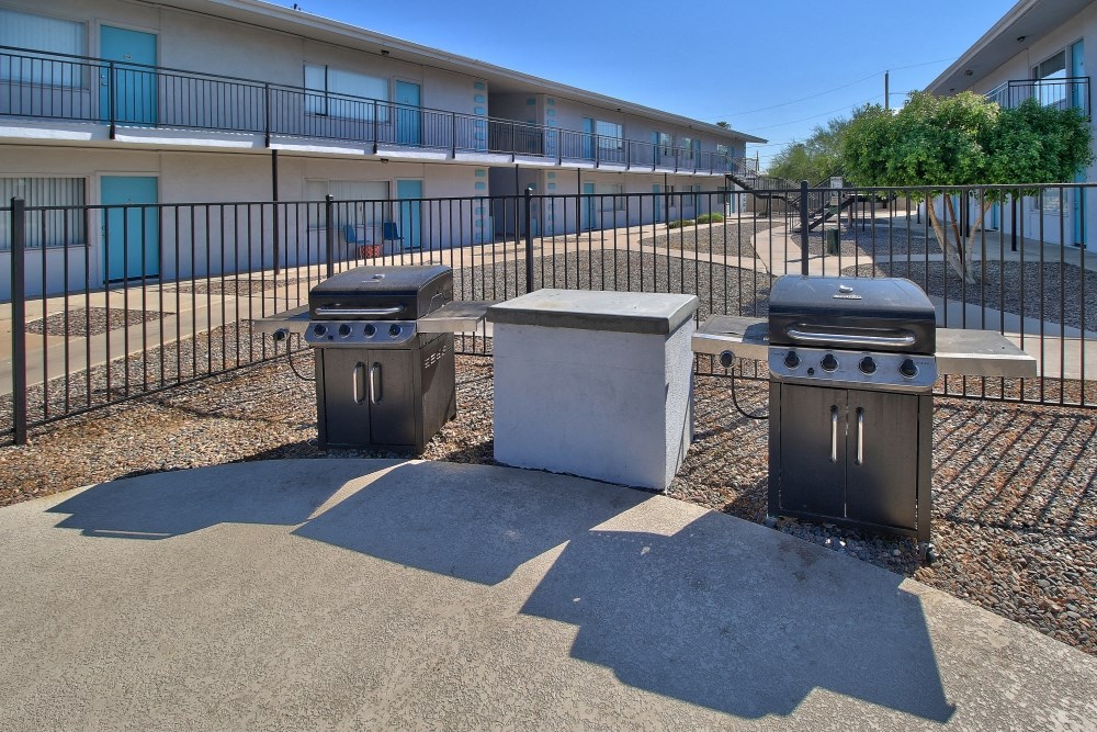 three stoves in front of a building with a fence
