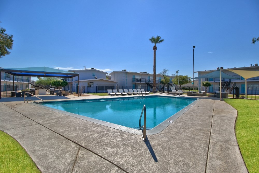 our resort style swimming pool is next to our apartment buildings and has chairs around it