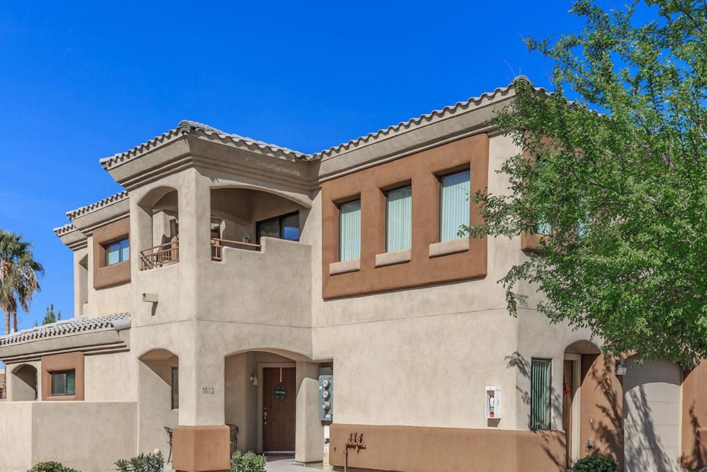 a large house with a tree in front of it