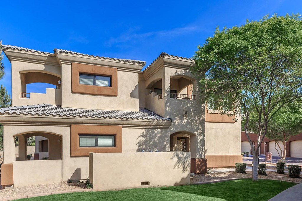 a large house with a tree in front of it