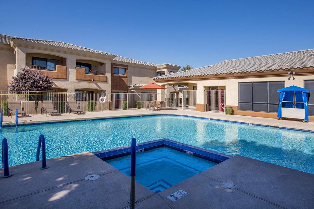 a swimming pool with a building in the background