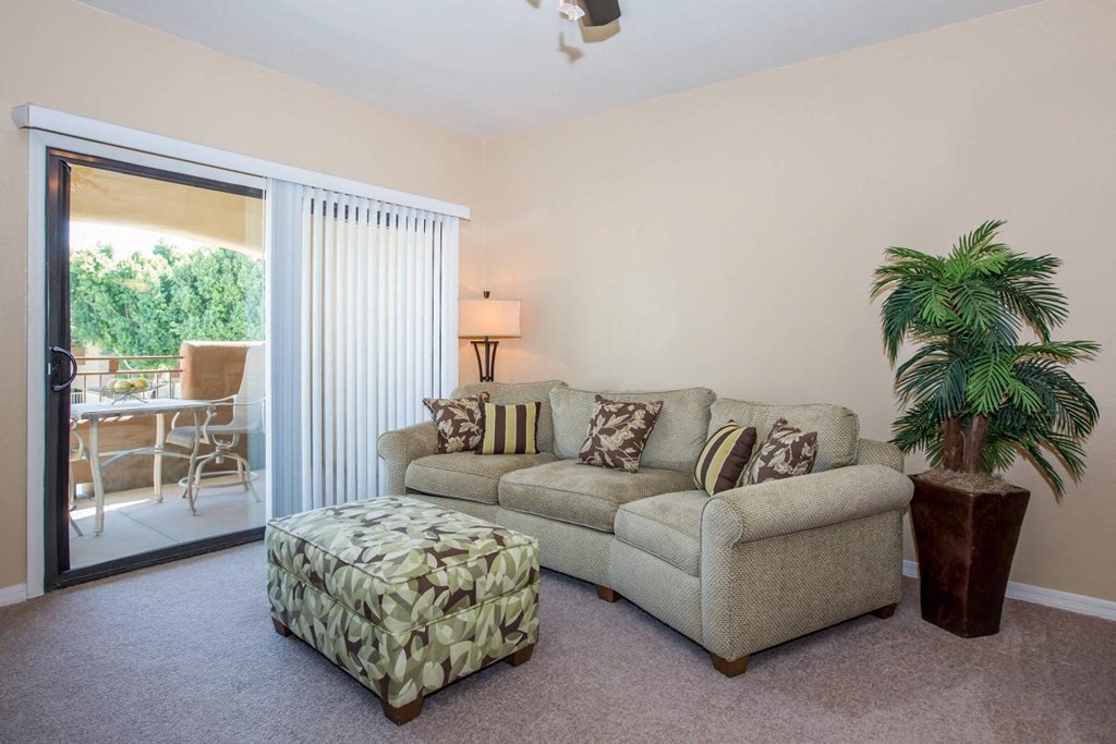 a living room with a couch and a and a sliding glass door