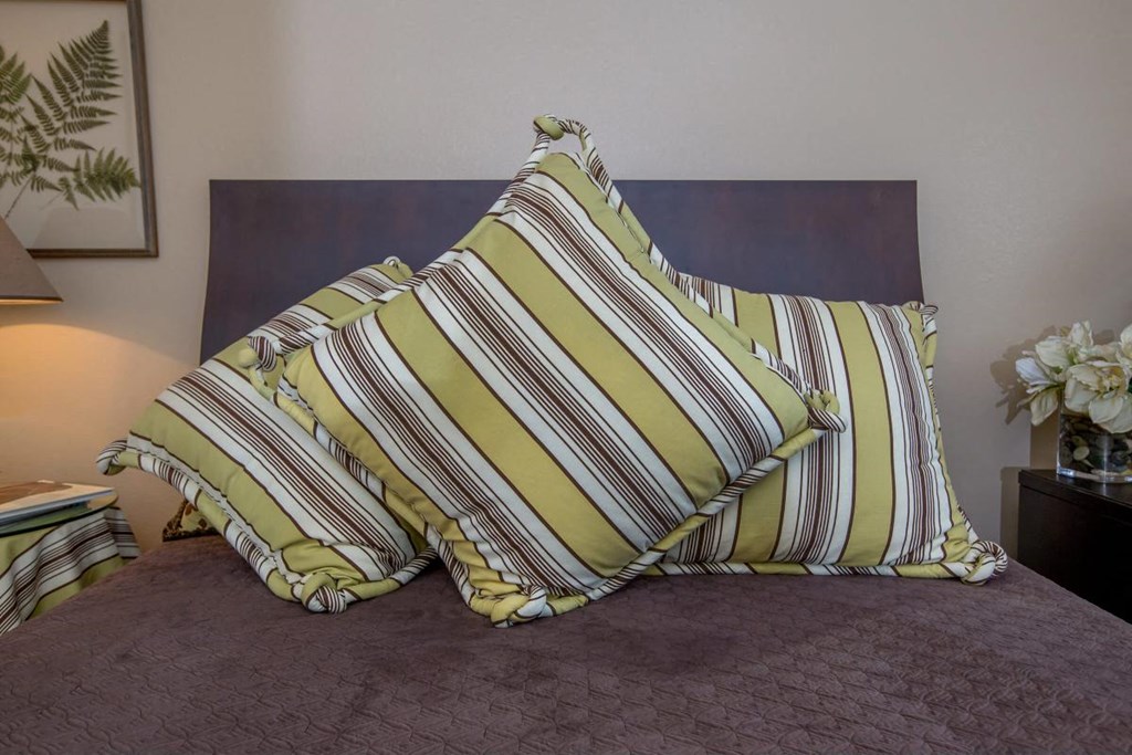 a bed with two pillows on top of it