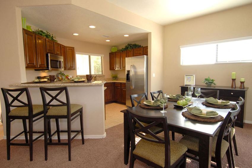 a kitchen and dining room with a table and chairs