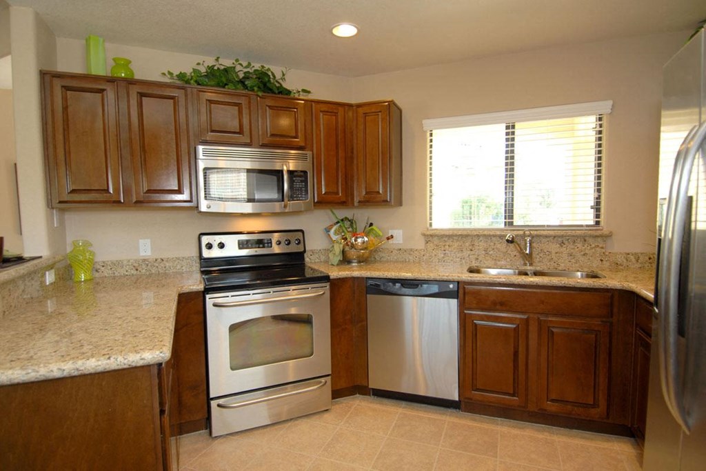 a kitchen with stainless steel appliances and a granite counter top