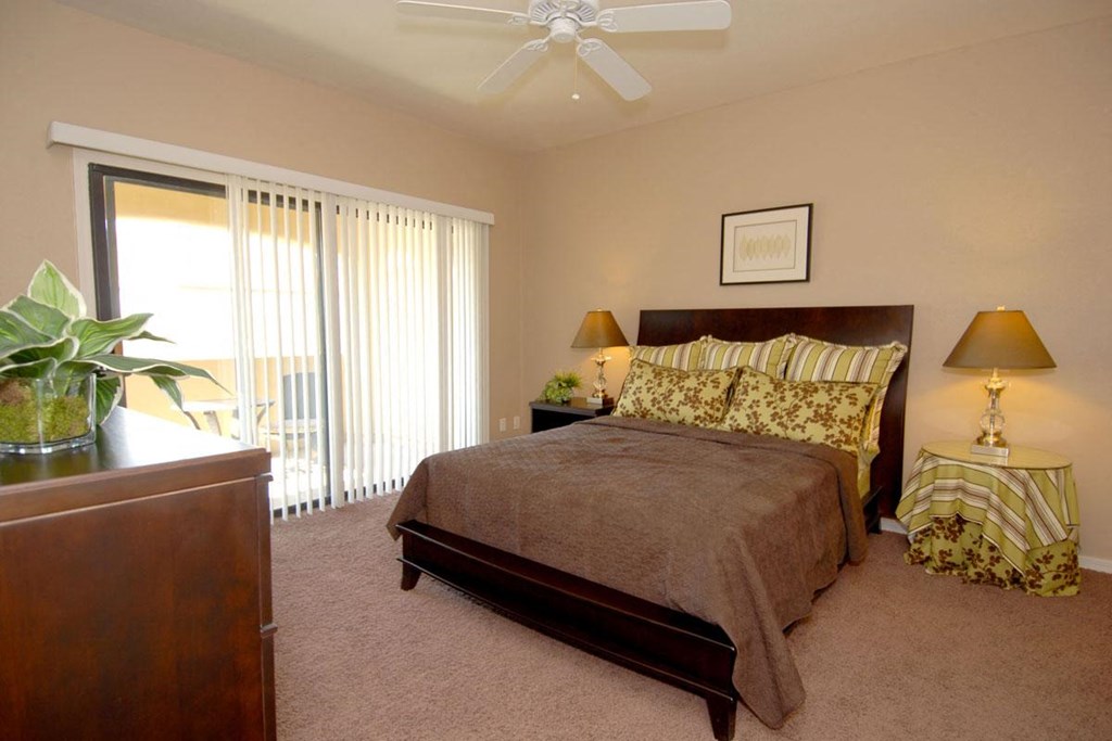 a bedroom with a bed and a ceiling fan