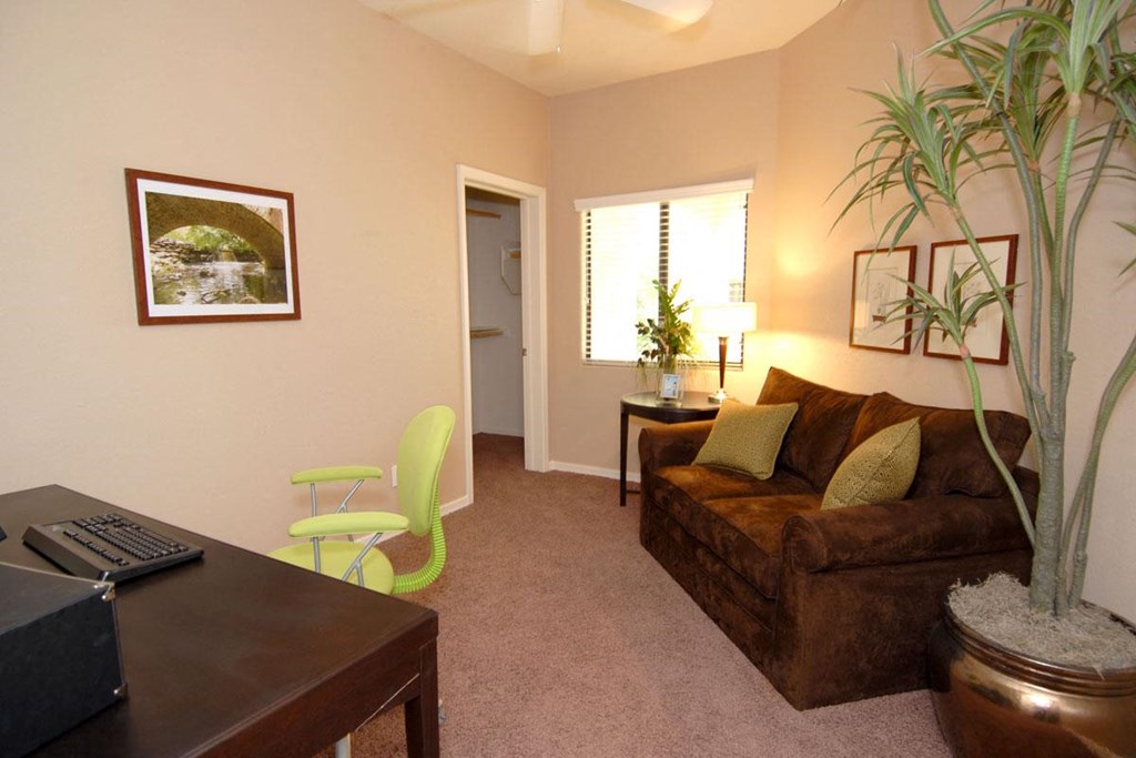 a living room with a couch and a desk