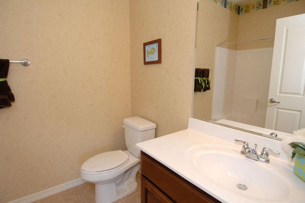 a bathroom with a sink toilet and a mirror