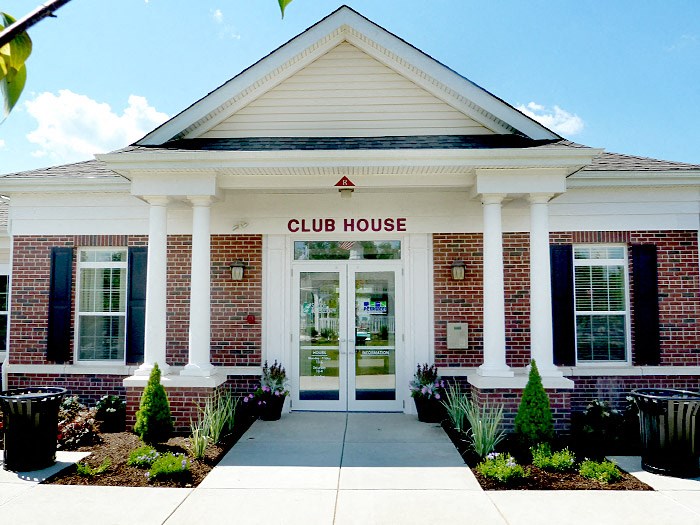 the club house is a brick building with white pillars