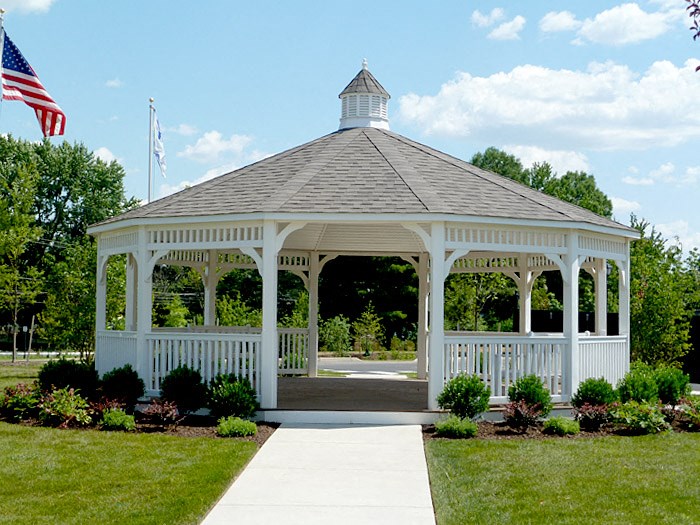 a gazebo with a walkway and an flag