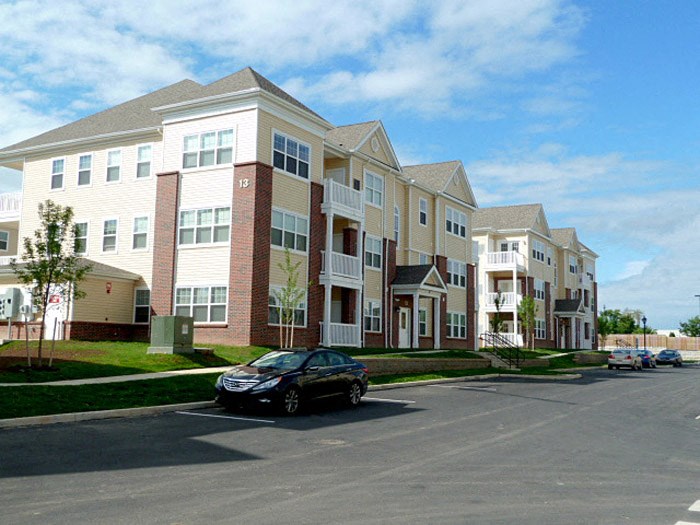 a car parked in front of an apartment building