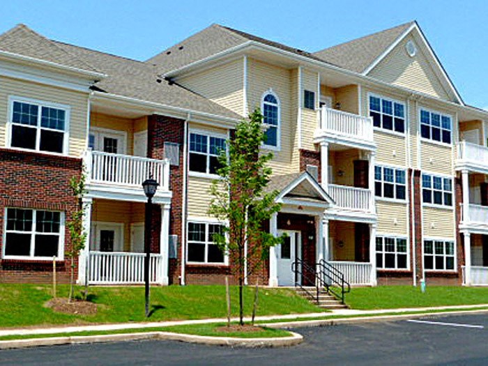 an apartment building with a street in front of it