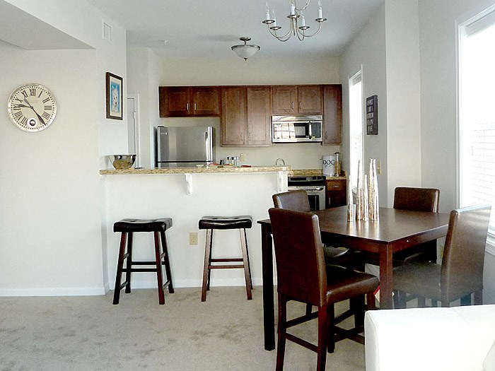 a kitchen and dining room with a table and chairs