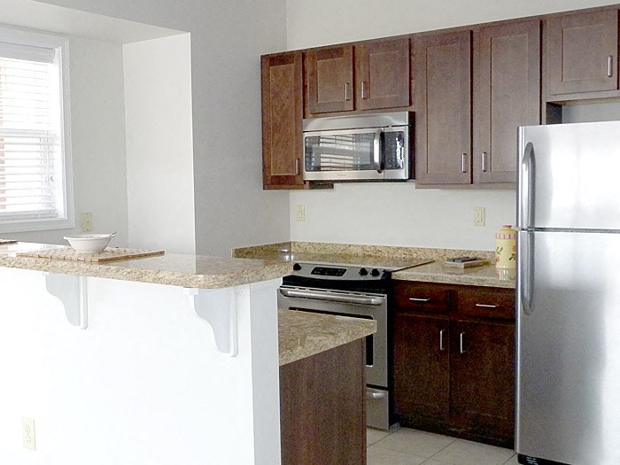 a kitchen with stainless steel appliances and granite counter tops