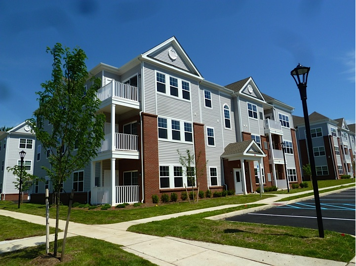 an exterior view of an apartment building on a sunny day
