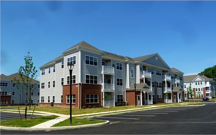 an apartment building on the corner of a street